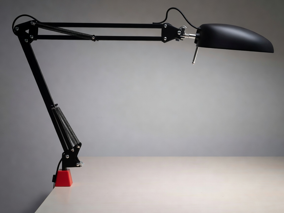 Counterbalanced articulated architectural desk luminaire in matte black